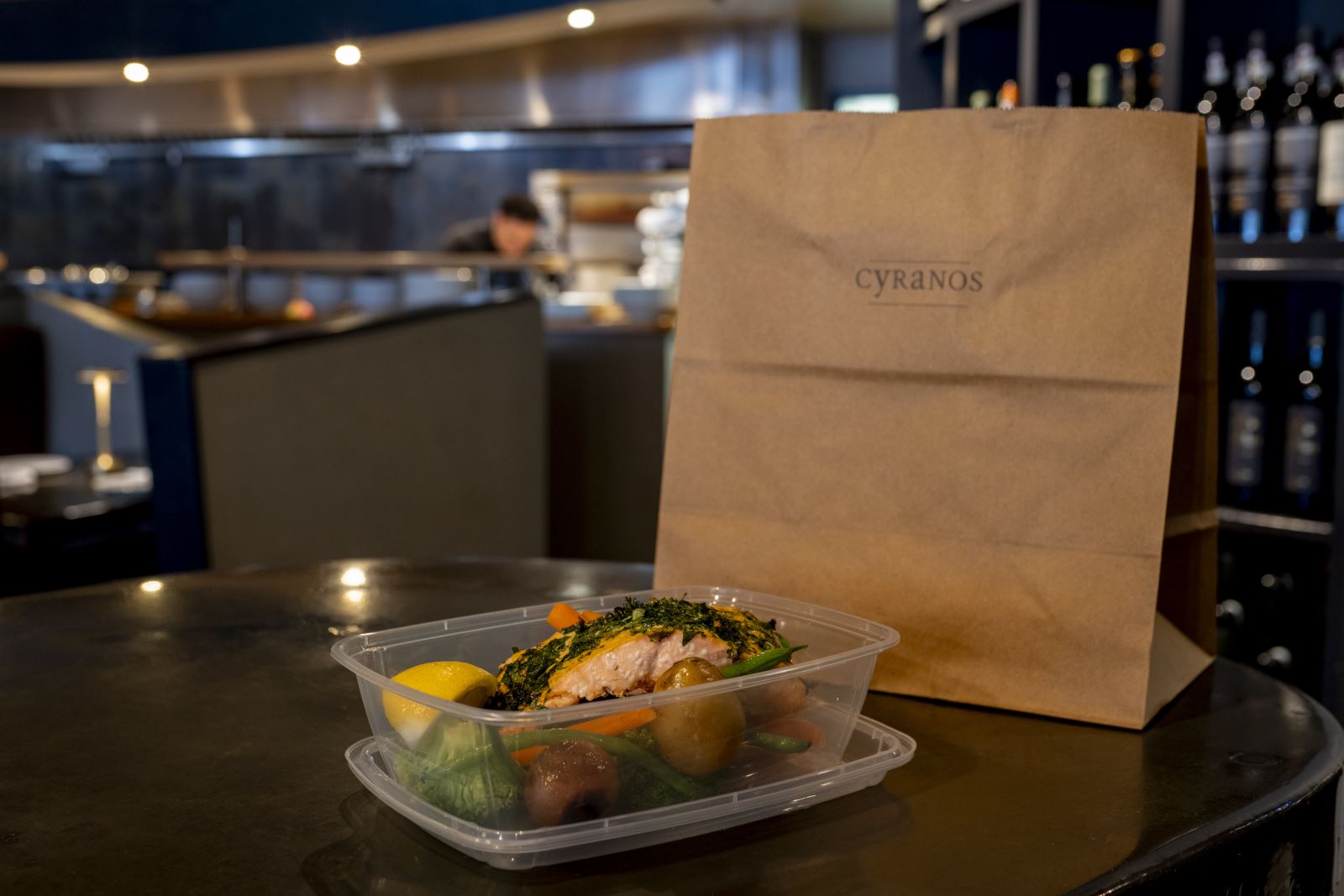 Cyranos takeout meal with branded bag
